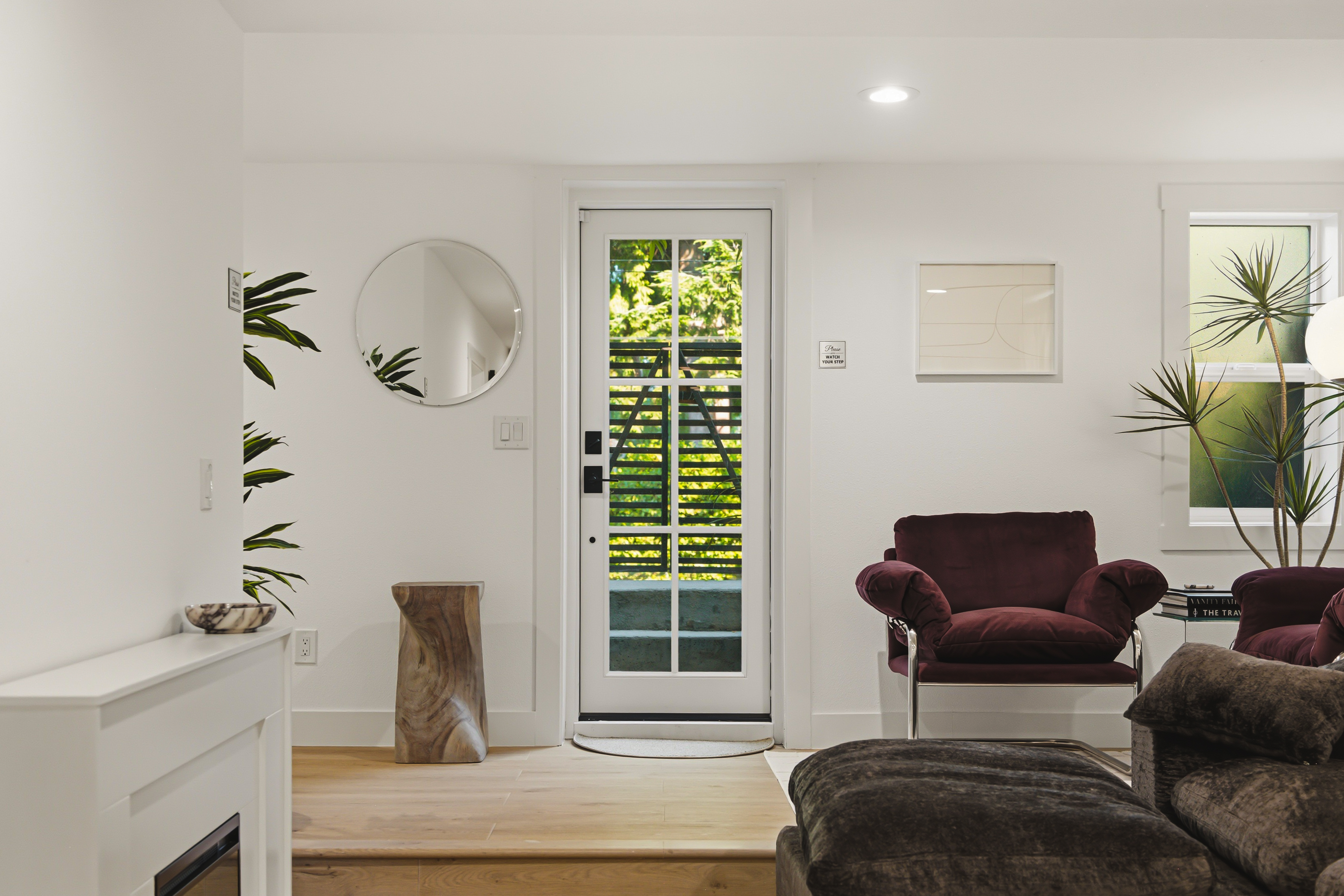 Burgundy velvet chairs beside the glass door to the courtyard