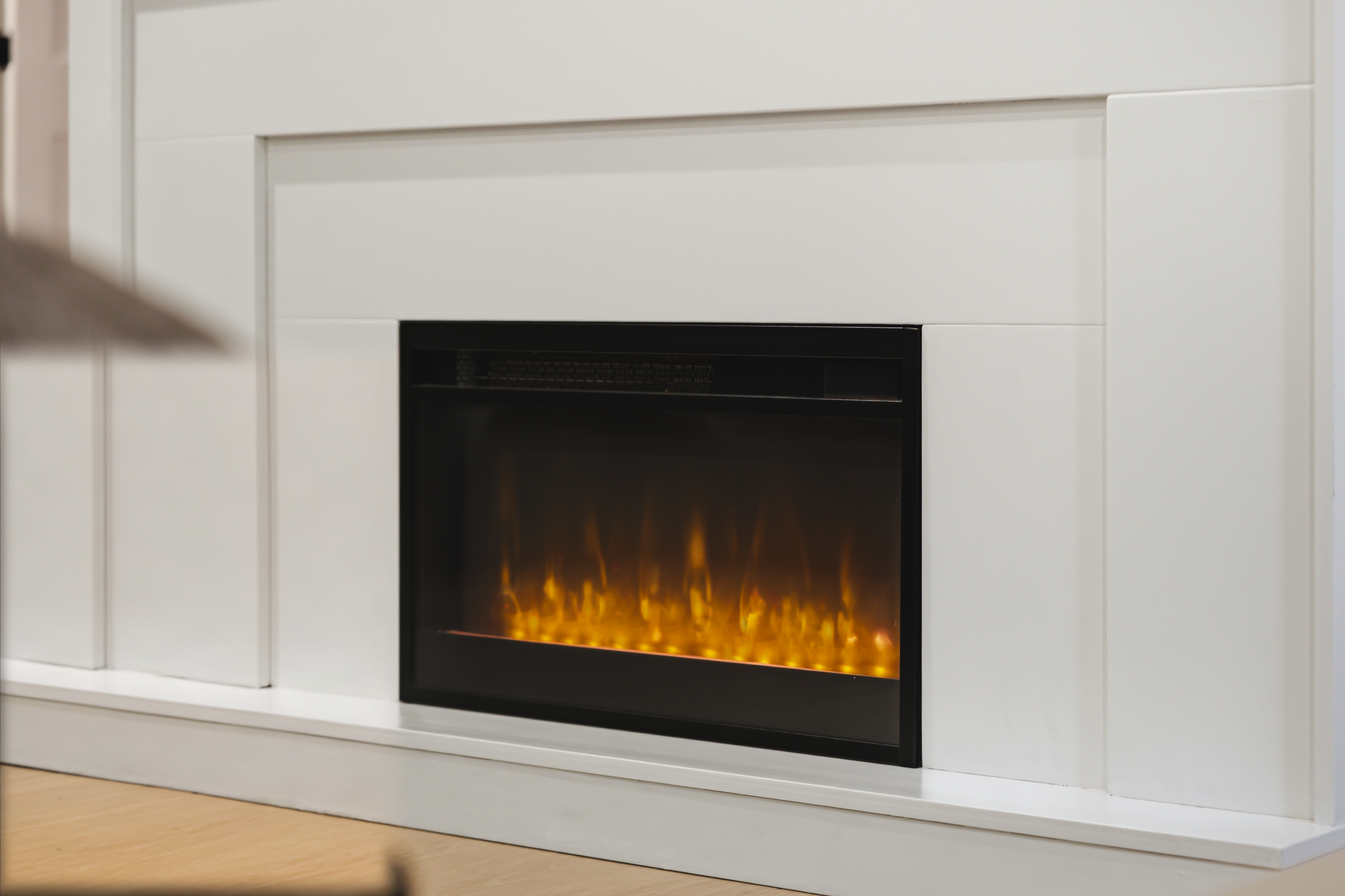 Electric fireplace set into a white mantel